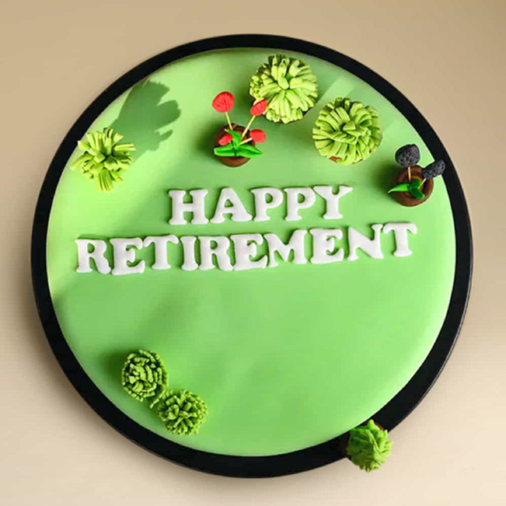 Green retirement cake with plants and “Happy Retirement” message. top view
