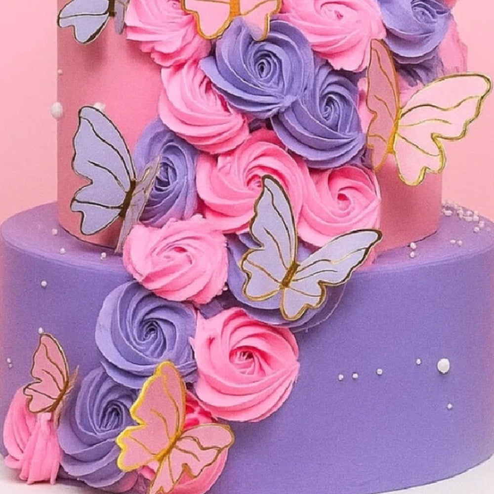 Number 4 cake with pink and purple flowers and butterflies on a pink background