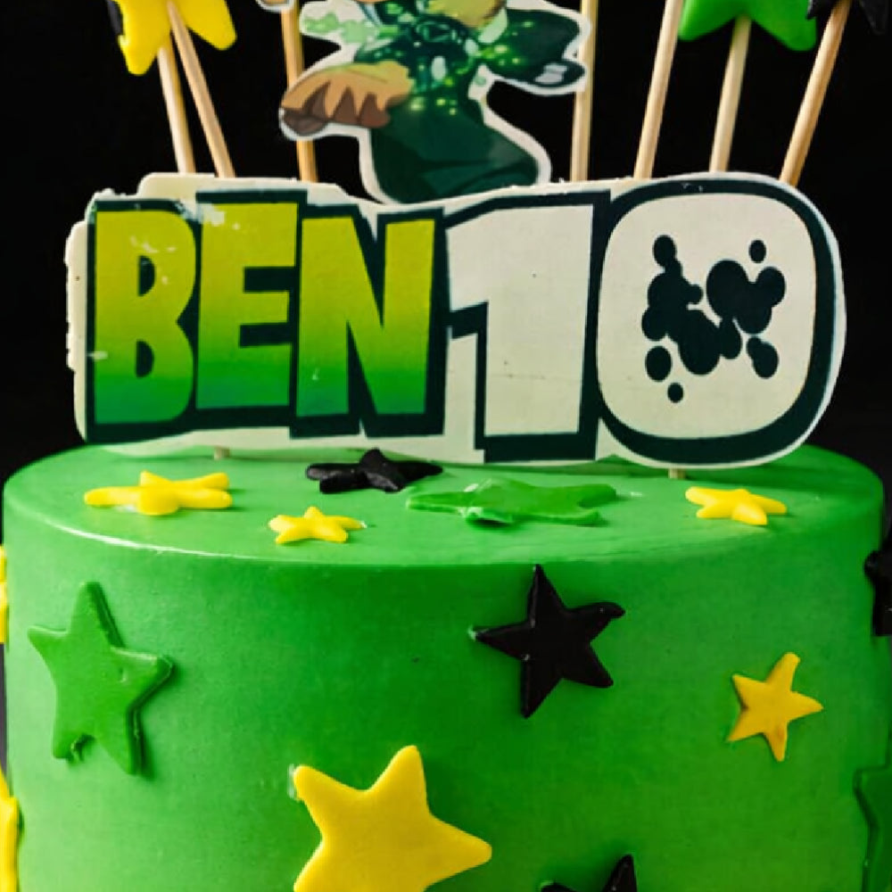 Ben 10 birthday cake with yellow and black stars, featuring a character topper