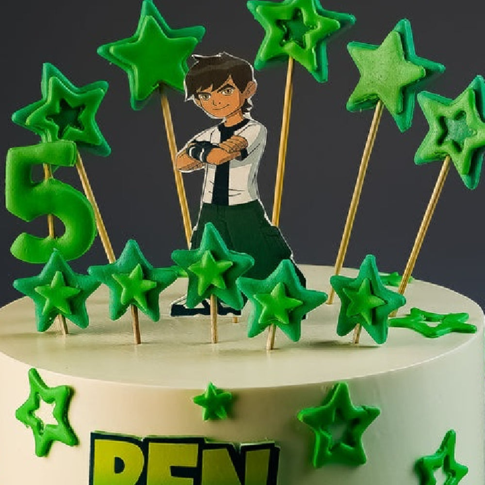 Ben 10 themed birthday cake with a character topper, green star decorations, and a "5" age candle.