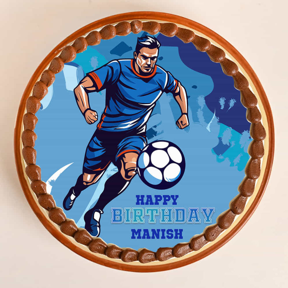 Birthday cake with a soccer player design and 'Happy Birthday Manish' text on a blue background.