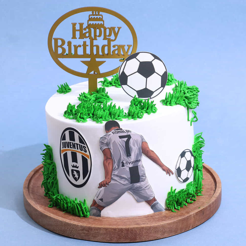 Birthday cake with Juventus logo, soccer ball, and player figure on a blue background