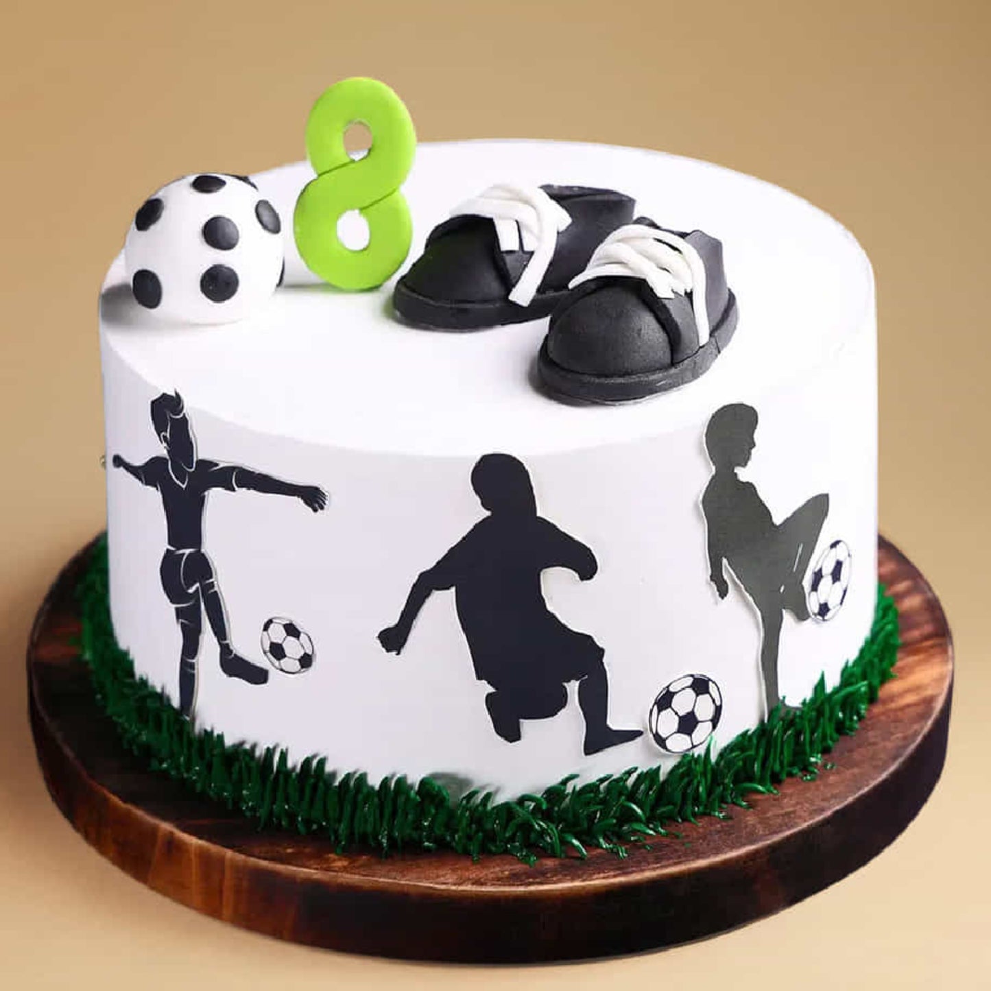 Cake with soccer-themed decorations and number 8 on a beige background