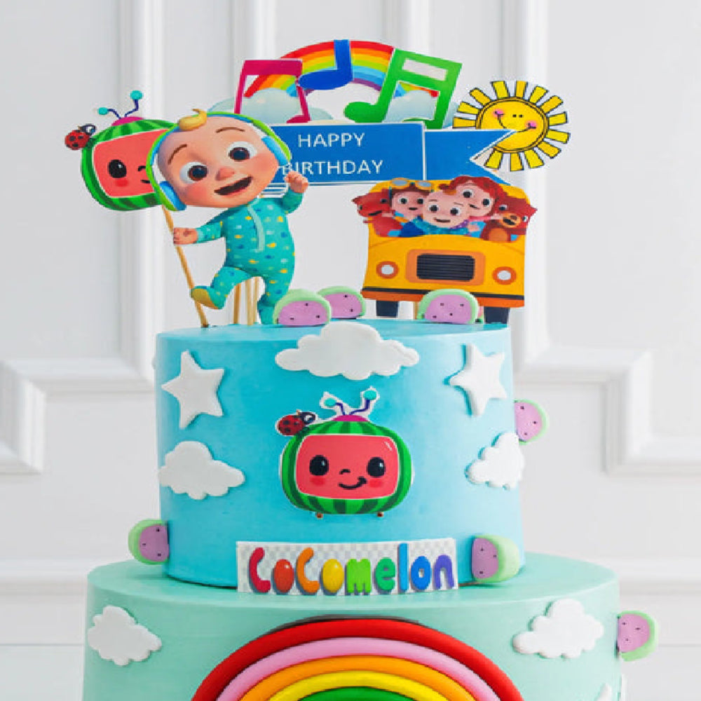Cocomelon themed designer birthday cake with cartoon characters, rainbow, musical notes, and happy birthday topper, perfect for a kids celebration.