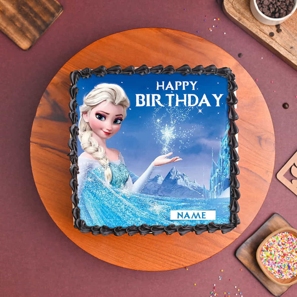 Birthday cake with Elsa from Frozen on a wooden board