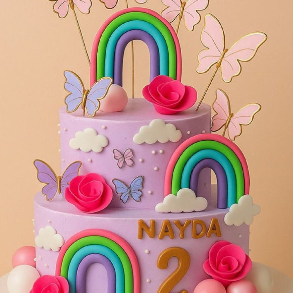Colorful birthday cake with rainbows, flowers, and butterflies on a beige background