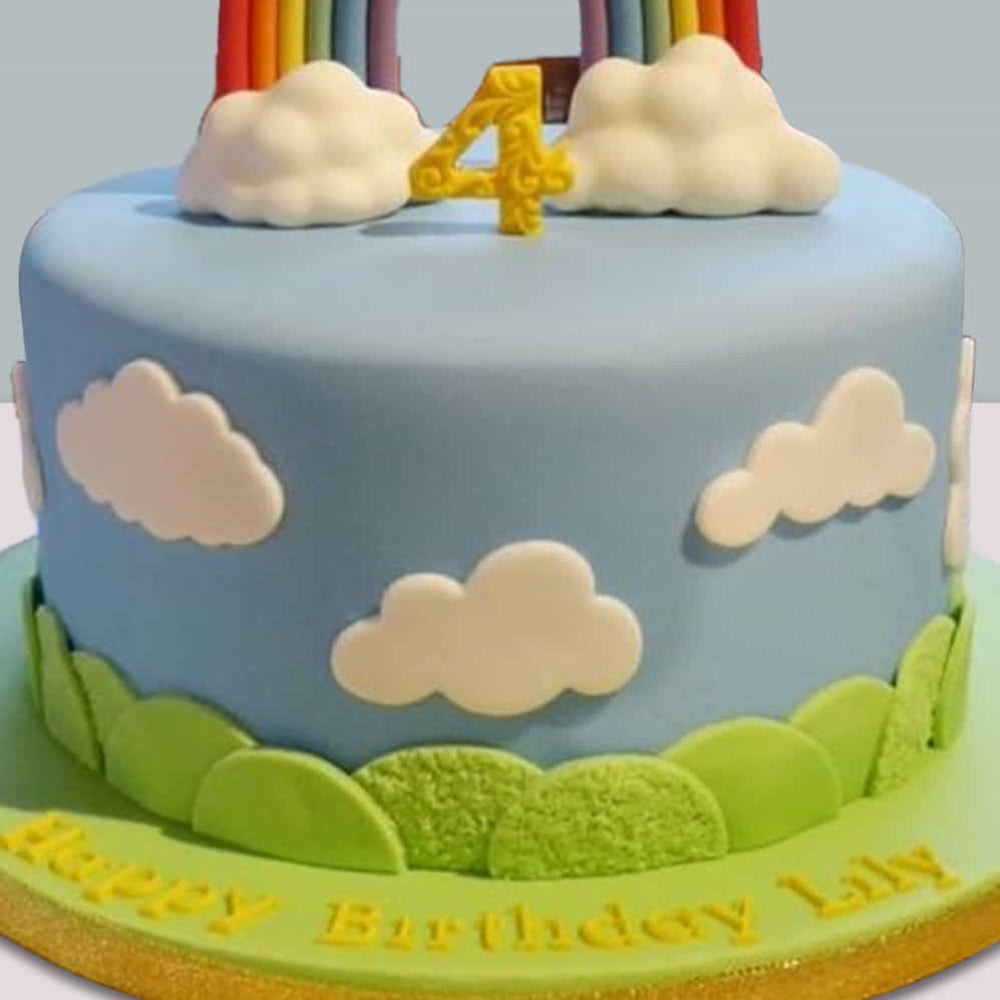 Children's birthday cake with clouds, number 4, and rainbow on a blue sky background.