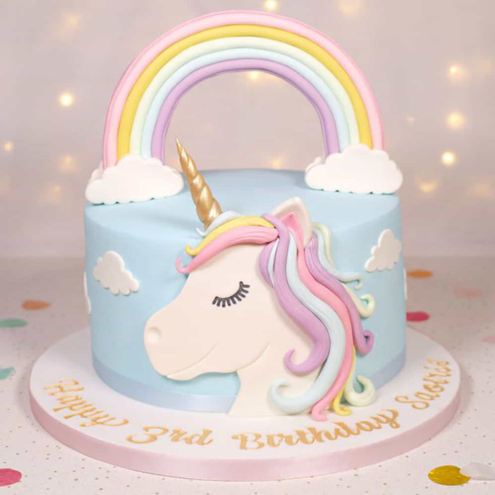 Unicorn cake with rainbow and clouds on a light background