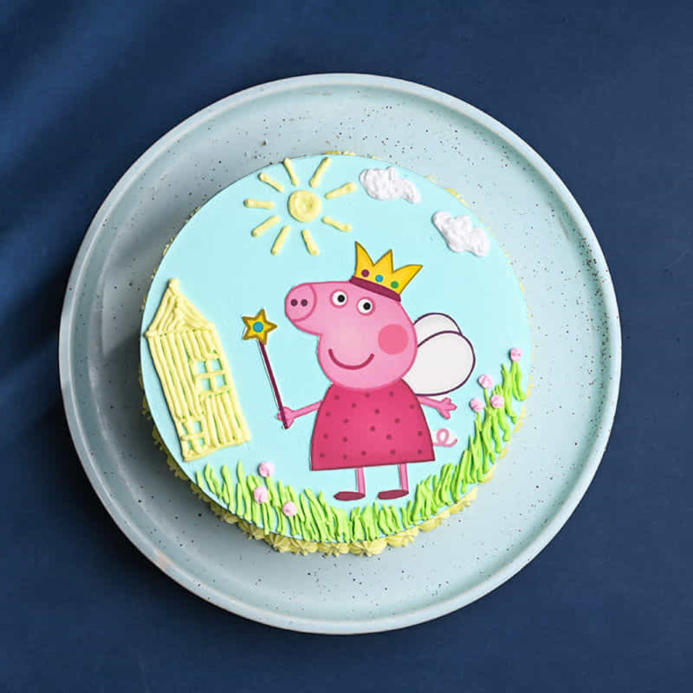 Princess Peppa Pig fairy themed birthday cake with blue frosting and yellow star piping