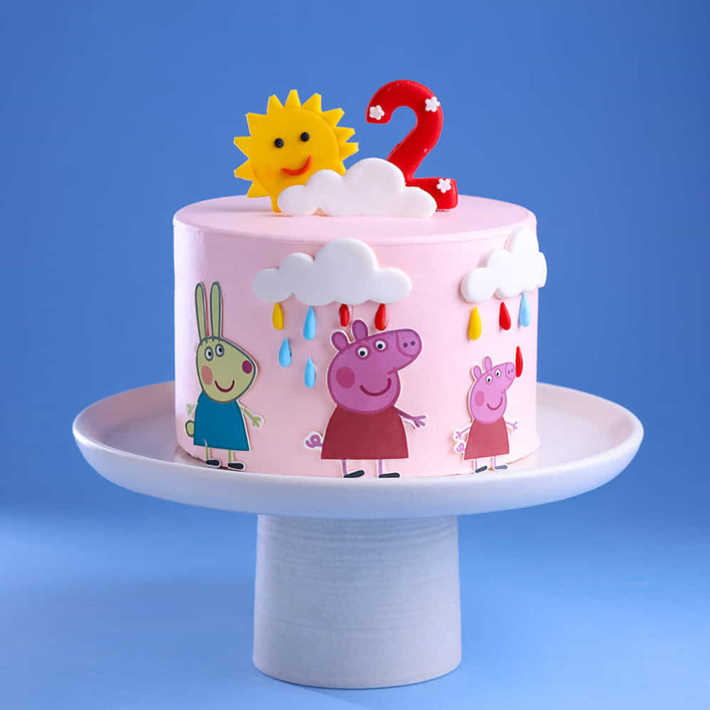 Peppa Pig theme designer cake with number 2 topper, clouds, and colorful rain design, perfect for kids birthday in Delhi.