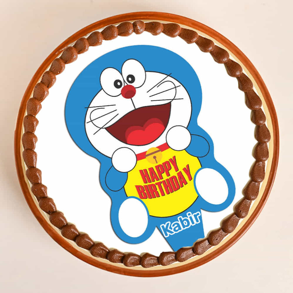Circular chocolate cake with a cartoon character and 'Happy Birthday' text on a beige background