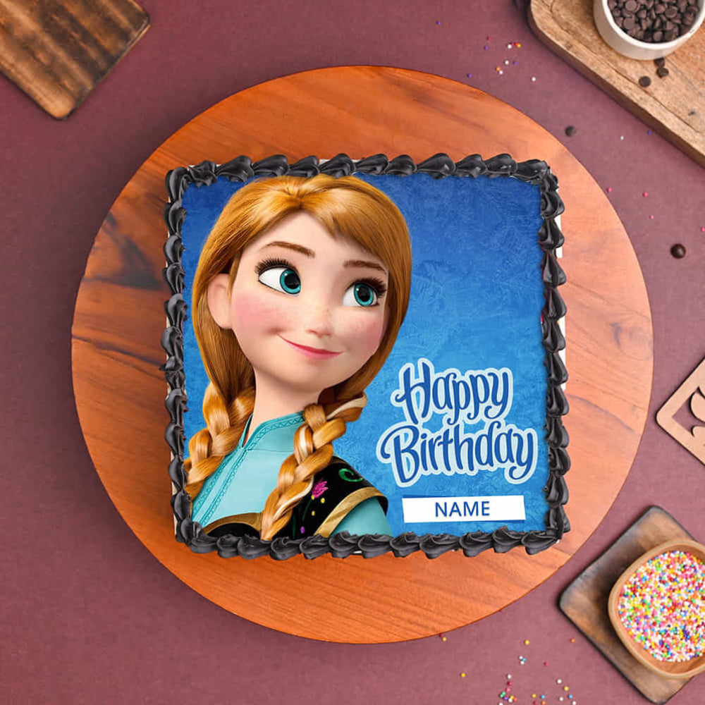 Frozen-themed birthday cake with character and 'Happy Birthday' text on a wooden board.