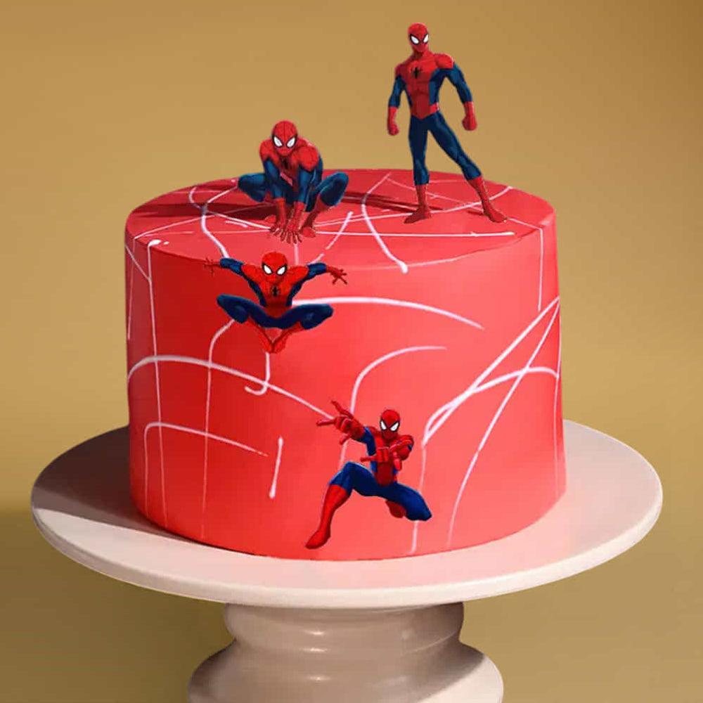 Red cake with Spider-Man figures on a yellow background