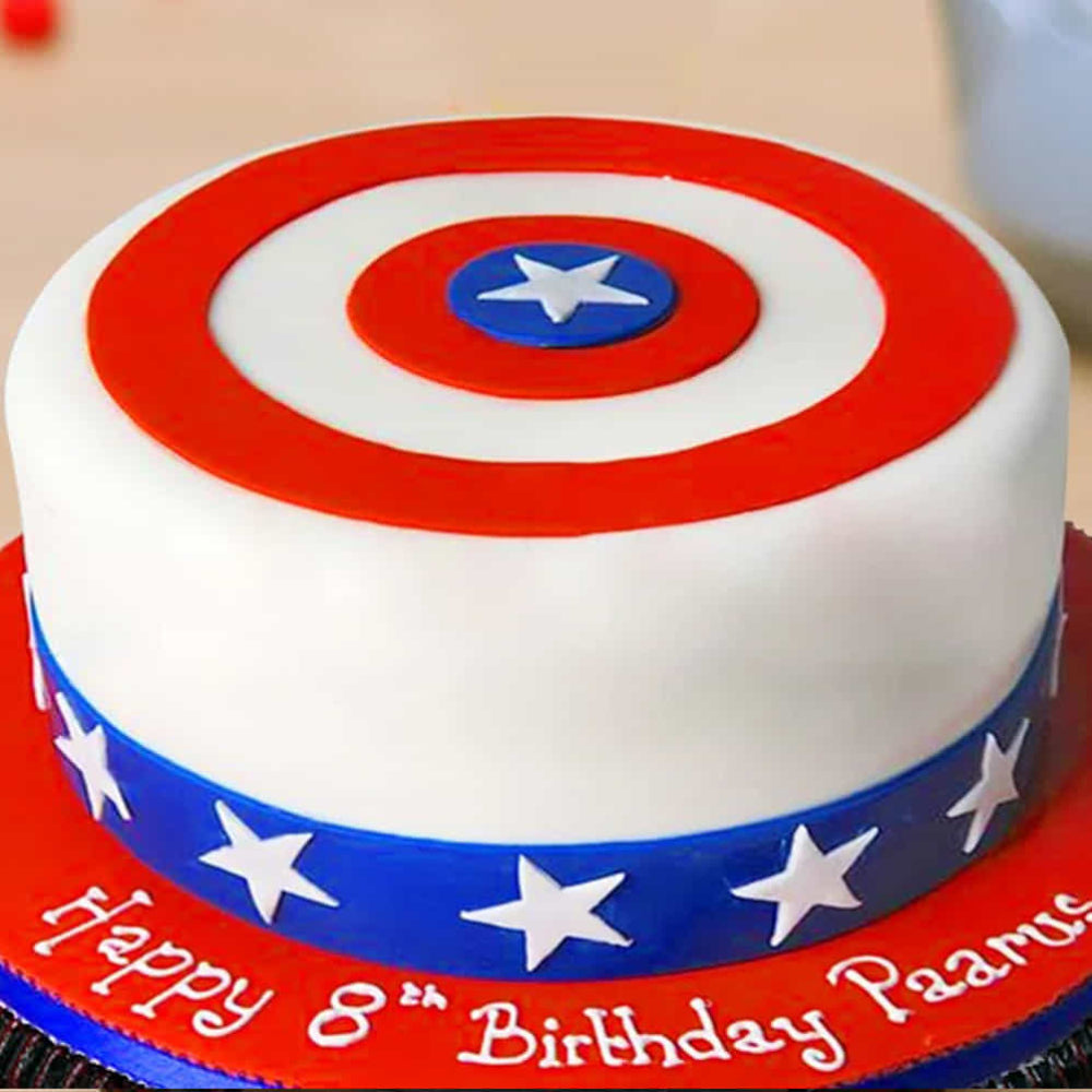 Birthday cake with Captain America shield design and 'Happy 8th Birthday Paarus' text.