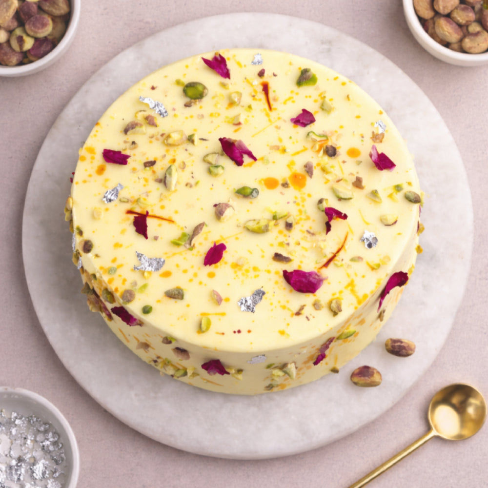 Elegant fusion designer cake with saffron, rose petals, and pistachio, perfect for celebrations. top view