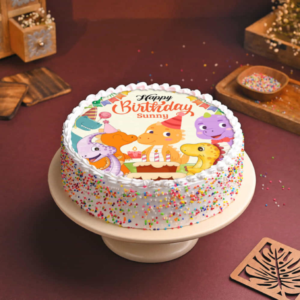 Birthday cake with cartoon characters on a wooden table