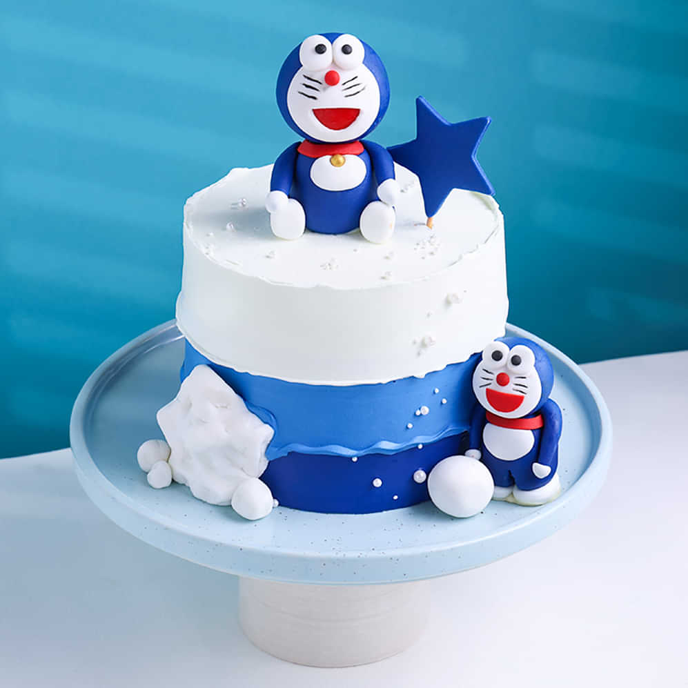 Two-tier cake with Doraemon figurines on a blue background