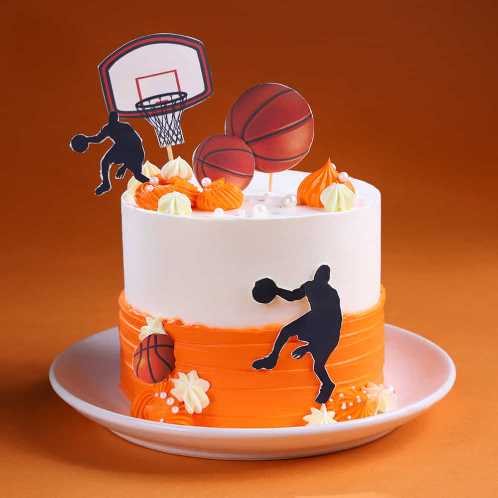 Basketball-themed cake with decorations on an orange background