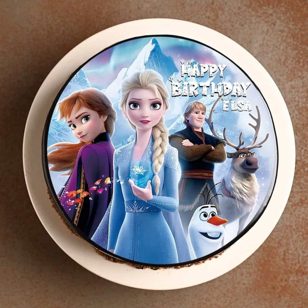 Round birthday cake topper with animated characters from 'Frozen' on a brown background