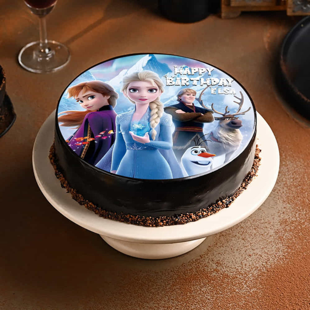 Frozen-themed birthday cake with characters on a white plate