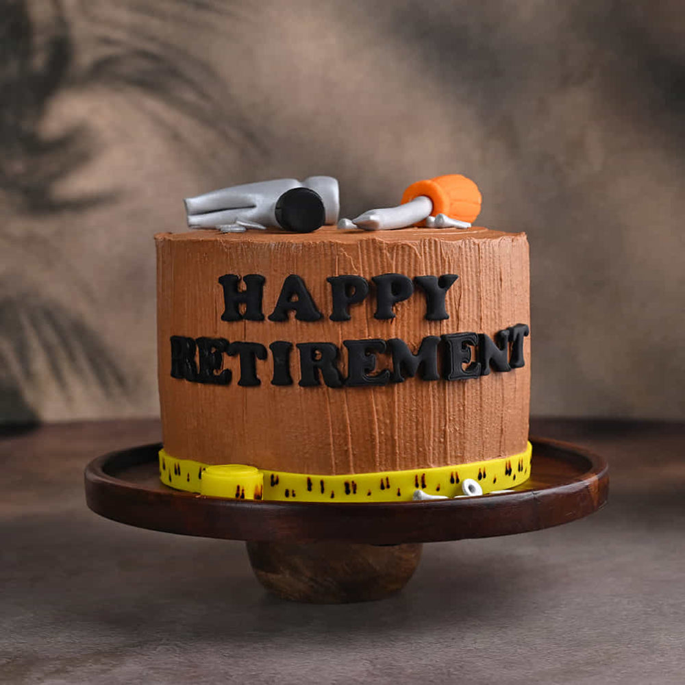Handyman theme cake with hammer, screwdriver, and “Happy Retirement” message. side view 