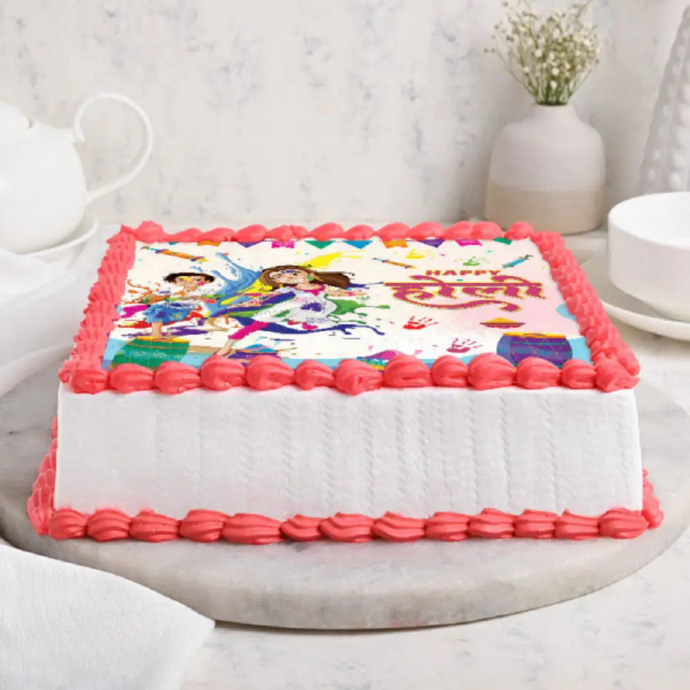 Square Holi festival cake with colorful edible cartoon print and red icing borders. side view