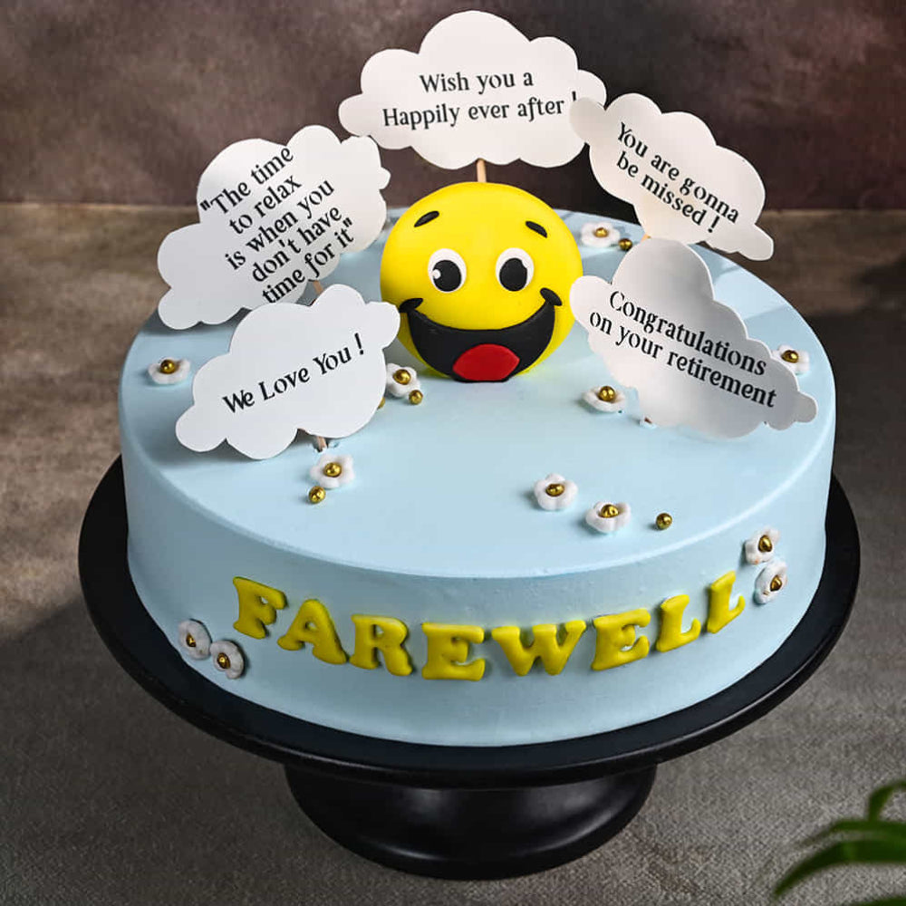 Light blue farewell cake with a smiley face topper and cloud-shaped messages.