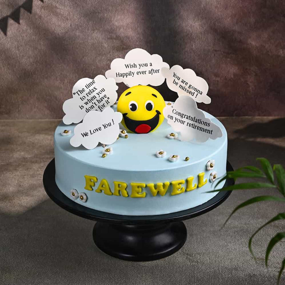 Light blue farewell cake with a smiley face topper and cloud-shaped messages.