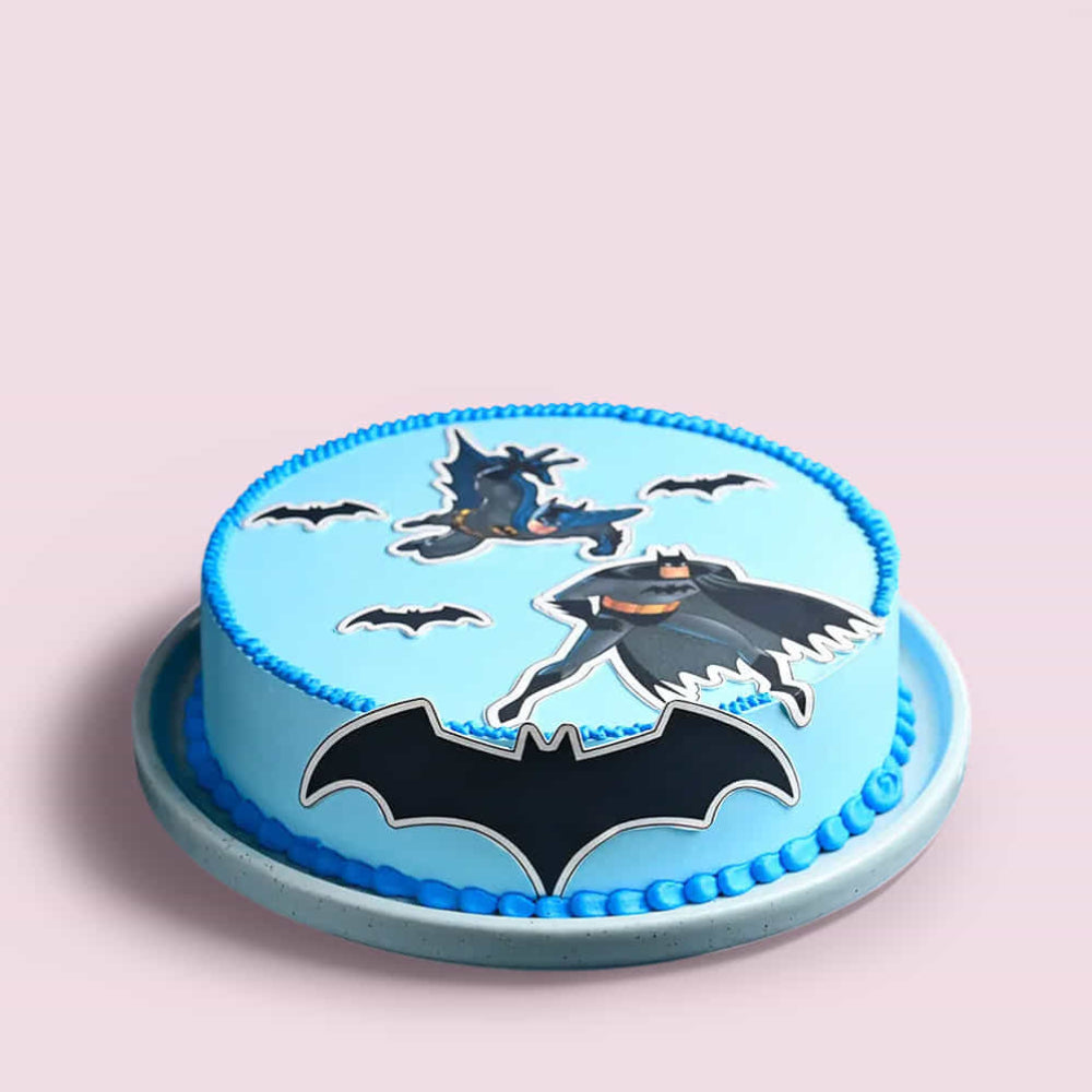 Cake with Batman design on a light pink background
