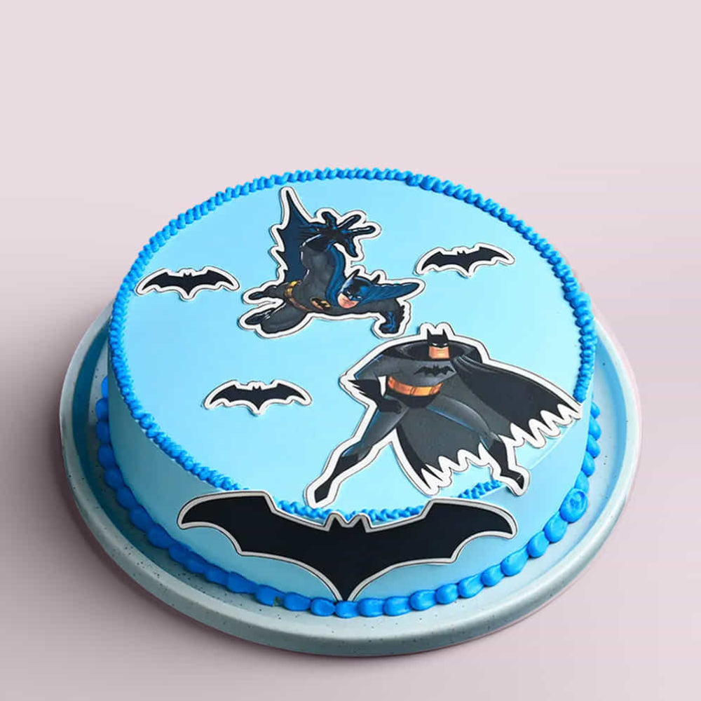 Cake with Batman design on a light blue background